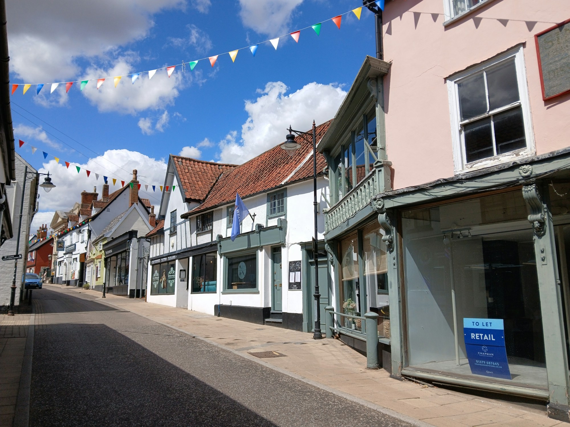 An English high street with a shop unit to let