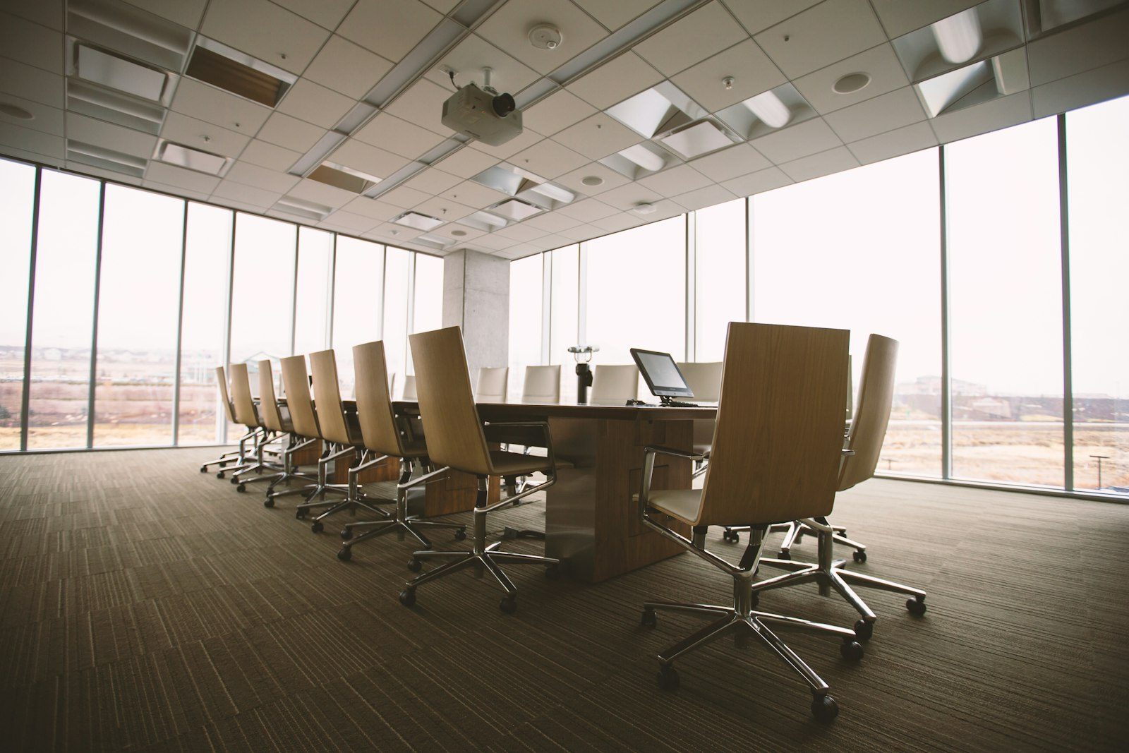 An empty boardroom table in afternoon light