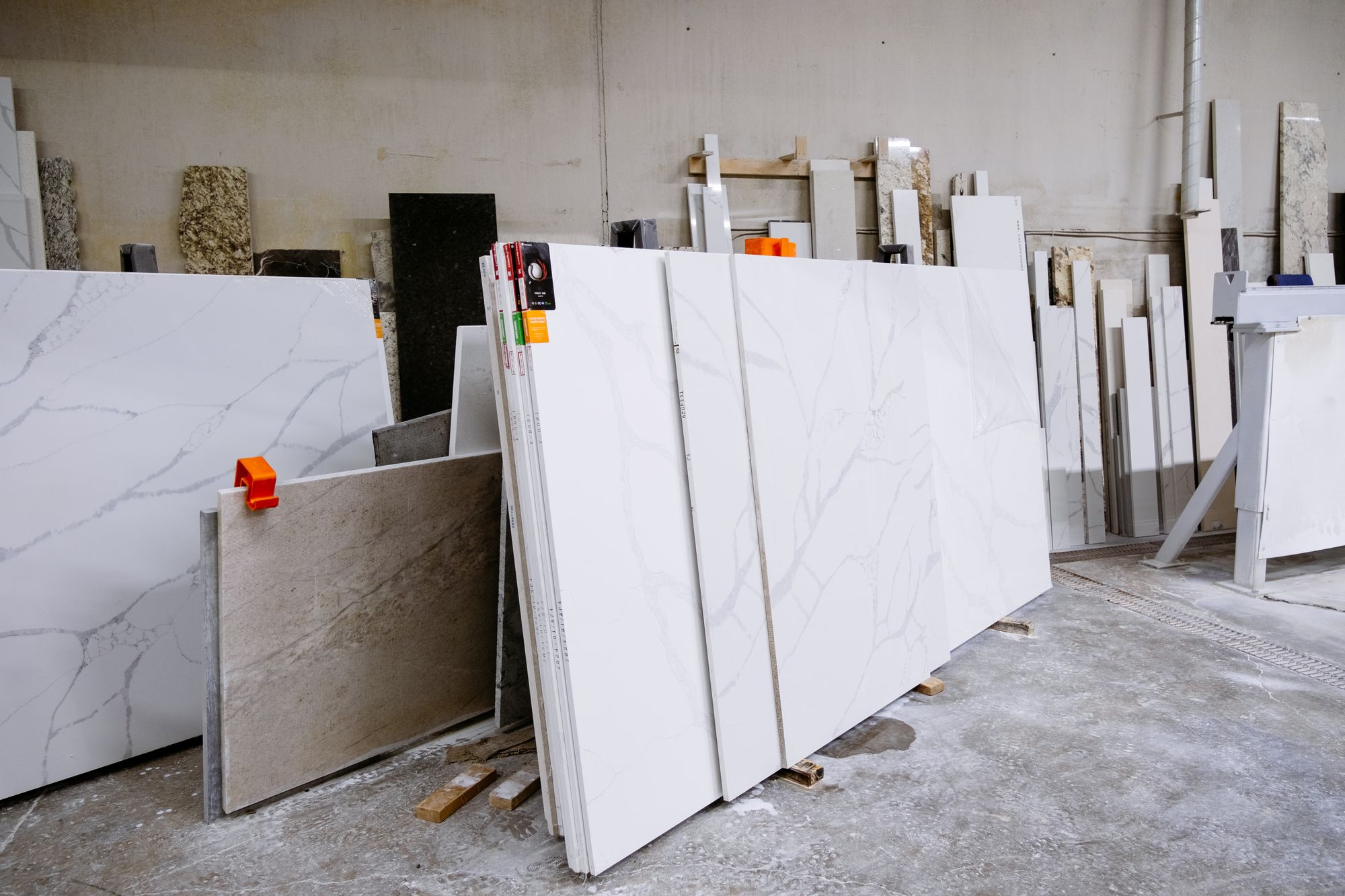 Porcelain and stone slabs racked in a tile business warehouse